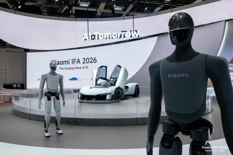 Vue large du stand Xiaomi avec la signature « Innovation for Everyone » et les robots humanoïdes, pour montrer l'ampleur de la présence